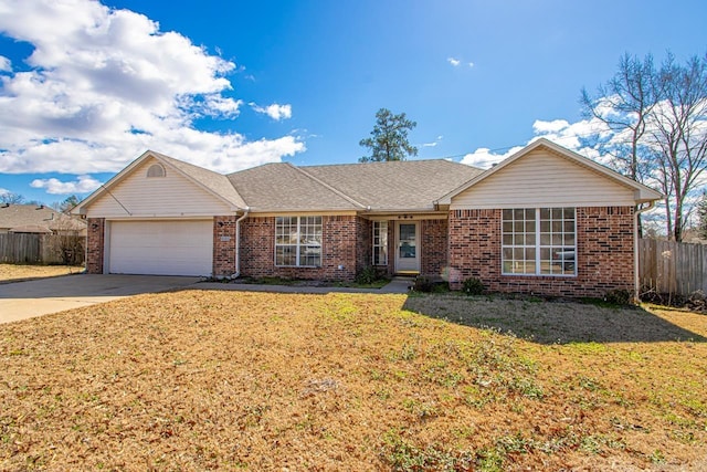 ranch-style home featuring brick siding, fence, a front yard, a garage, and driveway