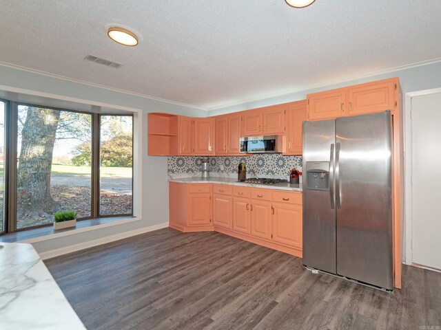 kitchen featuring visible vents, crown molding, decorative backsplash, stainless steel appliances, and dark wood-style flooring