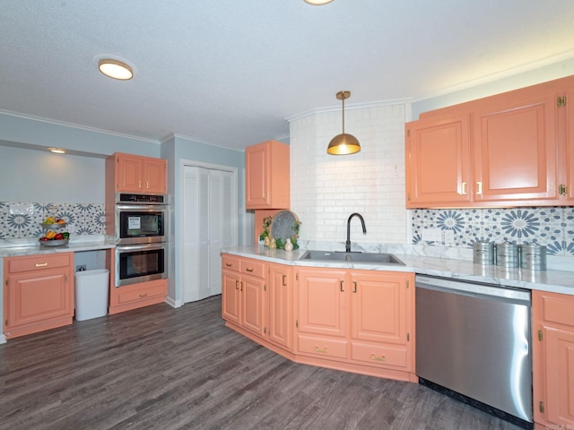 kitchen with a sink, stainless steel appliances, dark wood-style flooring, and light countertops