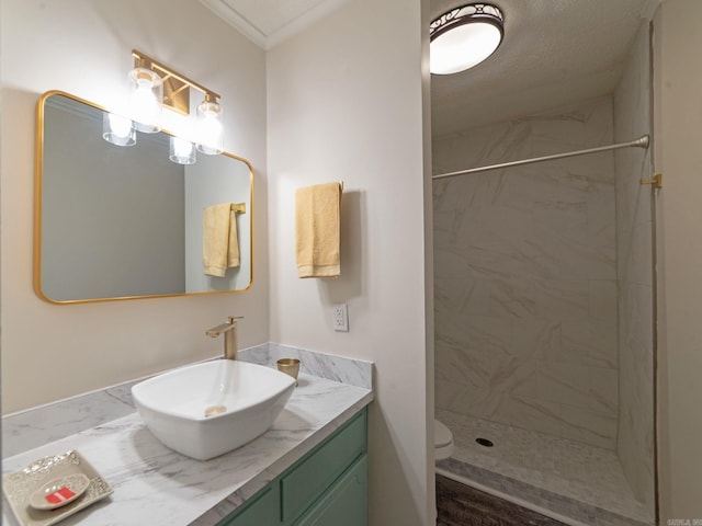 full bath featuring a shower stall, vanity, and toilet