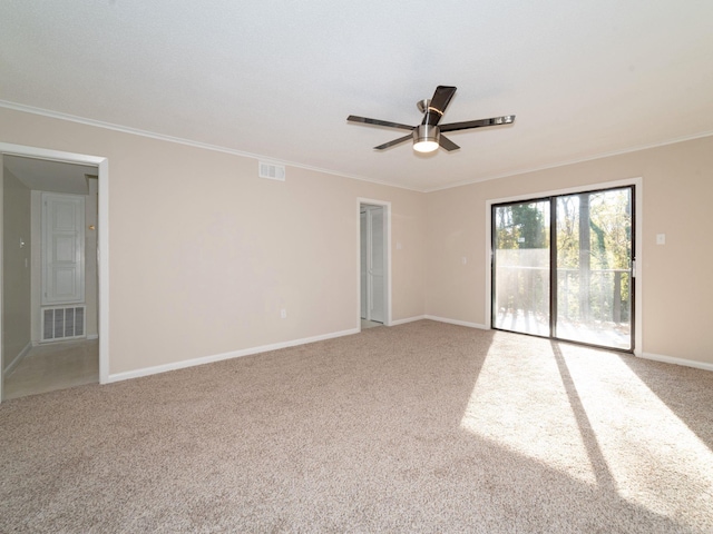 unfurnished room featuring visible vents, light colored carpet, baseboards, and ornamental molding