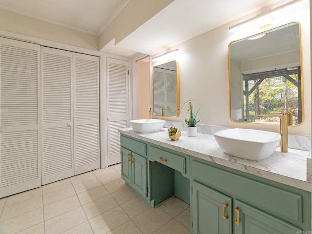 full bath featuring a sink, a closet, ornamental molding, and double vanity