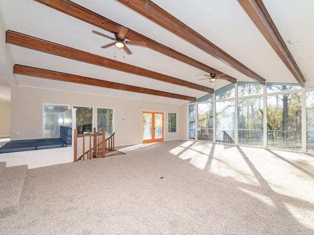 unfurnished living room with vaulted ceiling with beams and carpet flooring