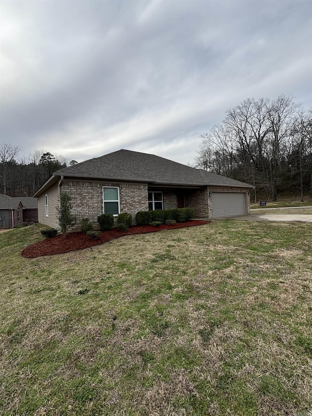 view of front of house with brick siding, a front yard, roof with shingles, driveway, and an attached garage