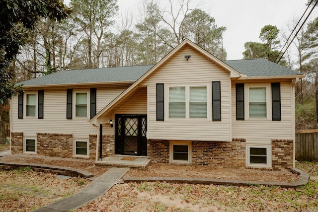 raised ranch with brick siding and roof with shingles