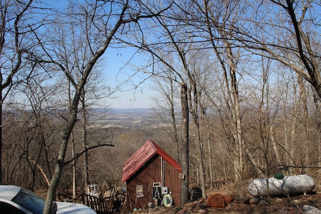 view of home's exterior with a view of trees