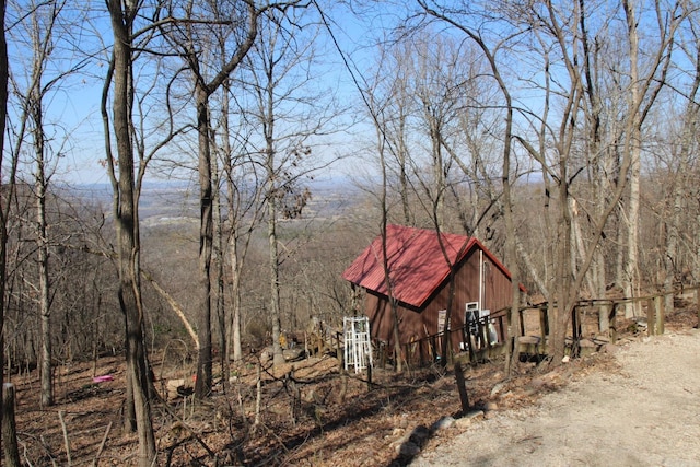 view of outbuilding with a view of trees