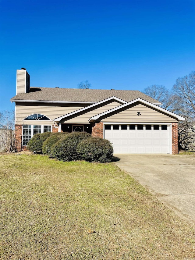 view of front of home featuring brick siding, a chimney, concrete driveway, and a front yard