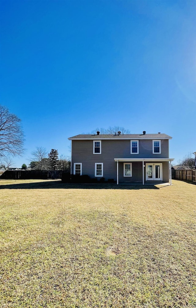 back of house featuring a yard