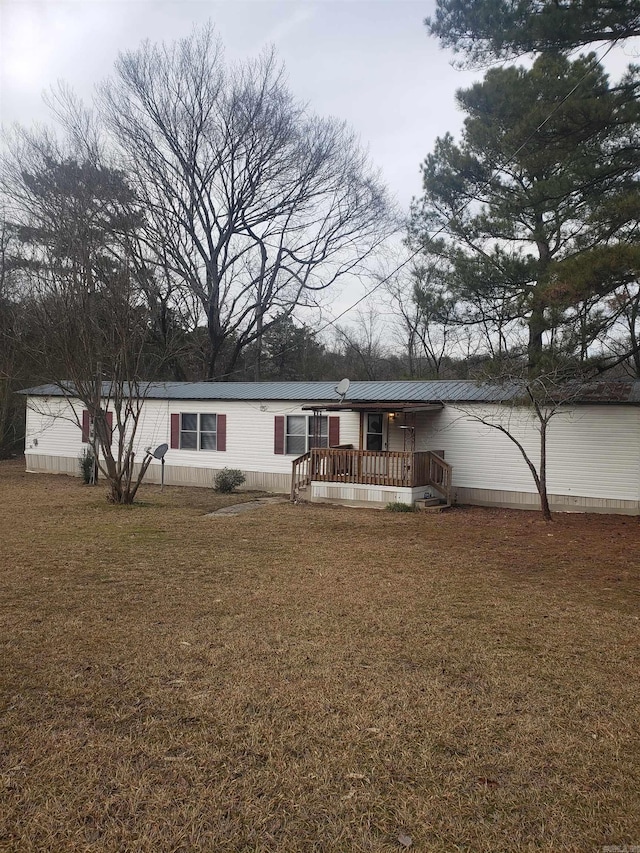 view of front of property featuring a wooden deck and a front yard