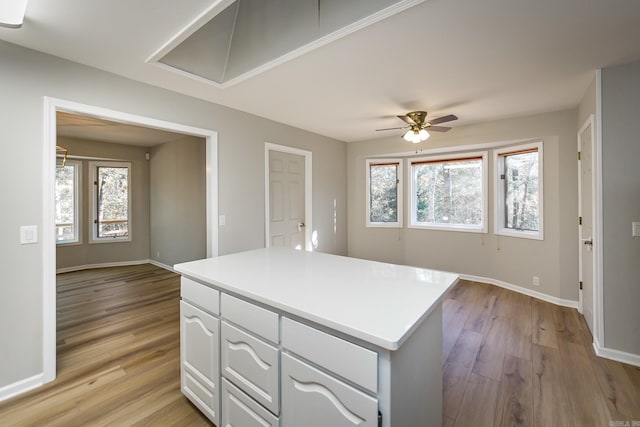 kitchen featuring plenty of natural light, light wood-style floors, and white cabinetry