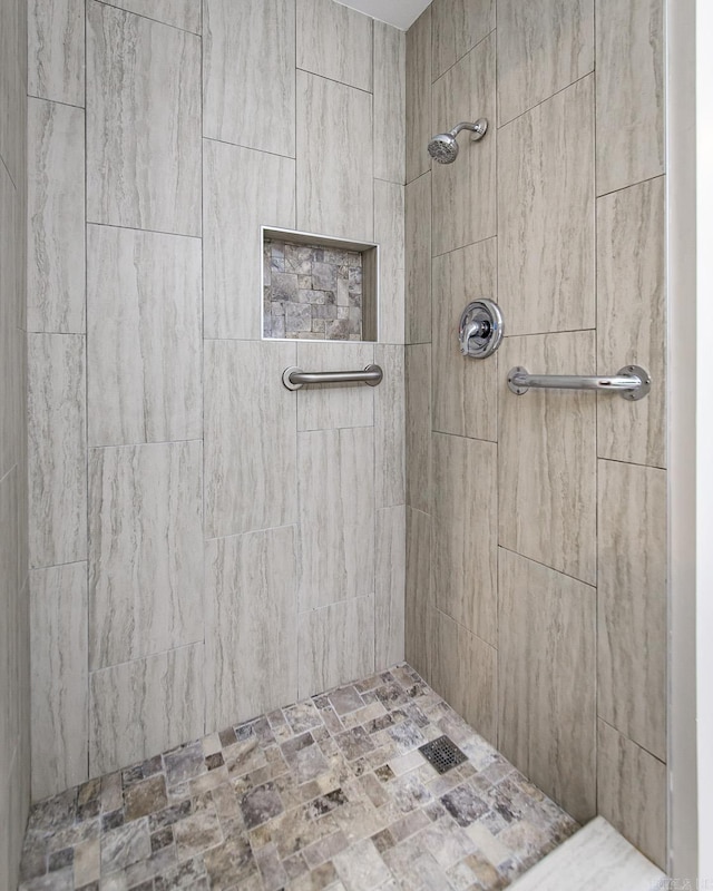 full bath with a tile shower