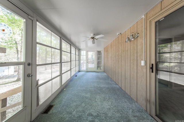 sunroom / solarium with visible vents and ceiling fan