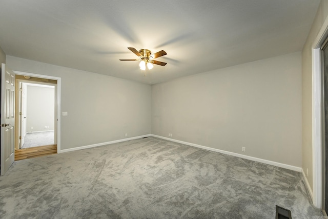 spare room featuring visible vents, baseboards, carpet, and ceiling fan