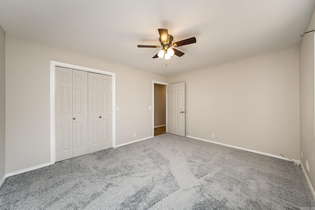 unfurnished bedroom featuring baseboards, carpet floors, a closet, and ceiling fan