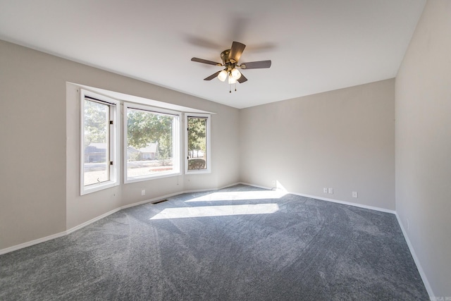 unfurnished room featuring visible vents, carpet flooring, baseboards, and ceiling fan