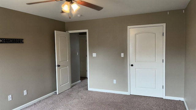 unfurnished bedroom with a ceiling fan, light colored carpet, and baseboards