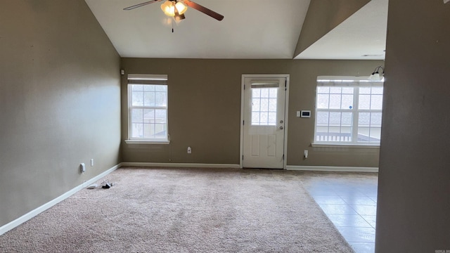 interior space with carpet flooring, lofted ceiling, baseboards, and a ceiling fan