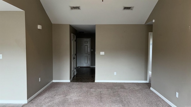 unfurnished room featuring visible vents, carpet floors, and baseboards