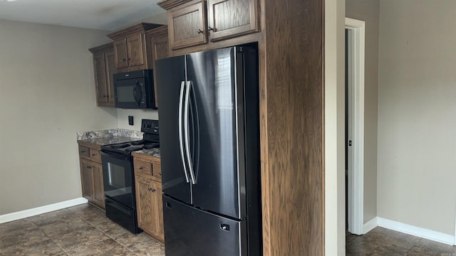 kitchen featuring baseboards and black appliances