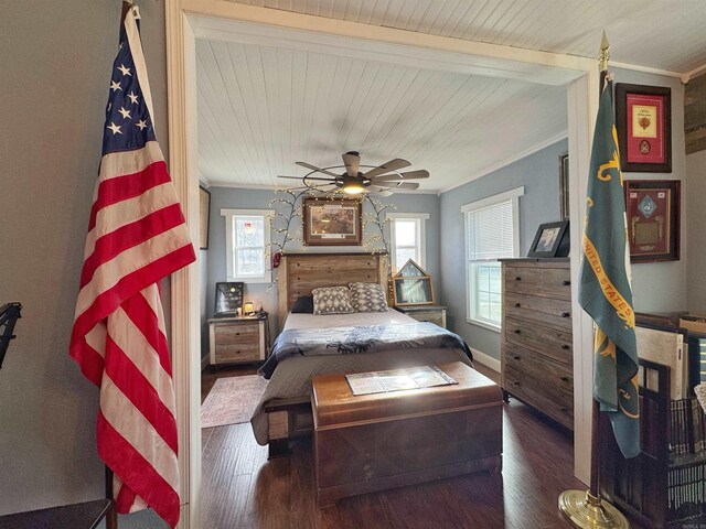 bedroom featuring wood ceiling, wood finished floors, baseboards, and ornamental molding