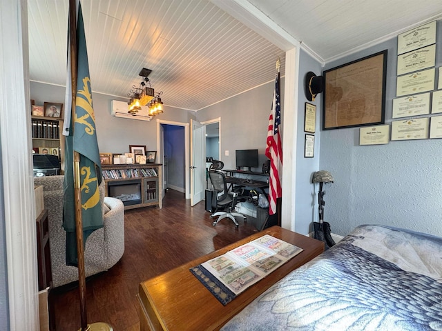 bedroom featuring wood finished floors, a fireplace, an inviting chandelier, a textured wall, and a wall mounted AC