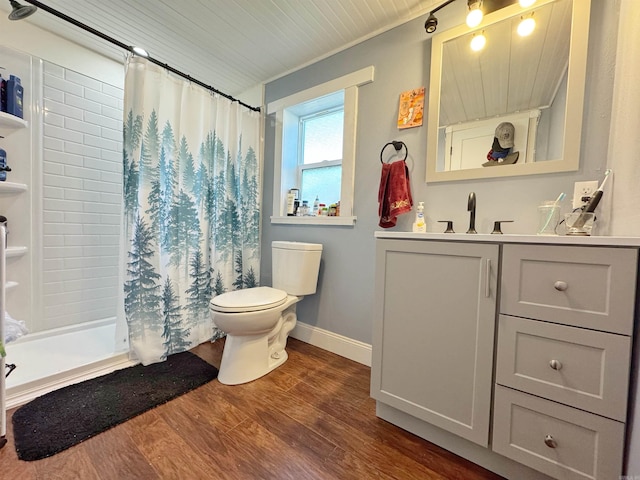 bathroom with curtained shower, toilet, vanity, and wood finished floors