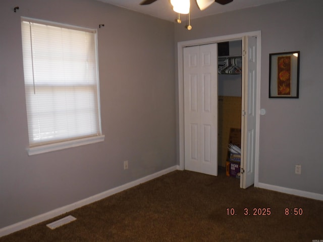 unfurnished bedroom featuring carpet, visible vents, a closet, and baseboards