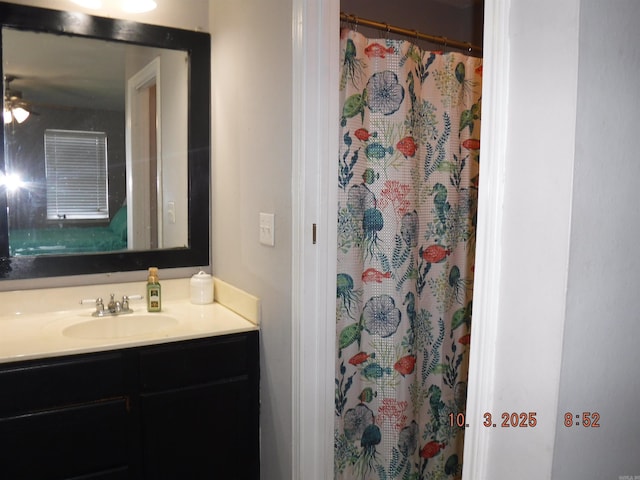 full bath with a shower with shower curtain and vanity