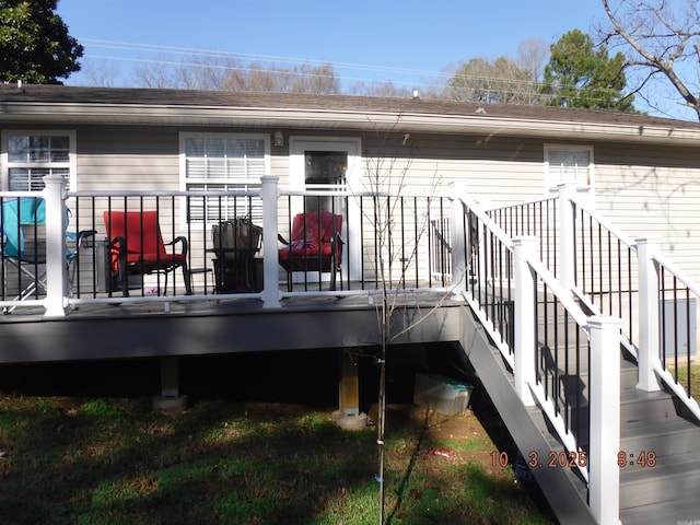 rear view of house featuring a wooden deck