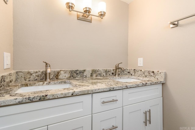 full bathroom featuring double vanity and a sink