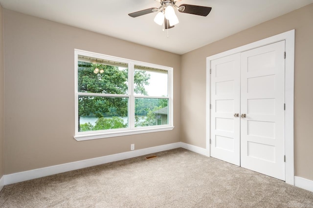 unfurnished bedroom featuring a closet, baseboards, visible vents, and carpet floors