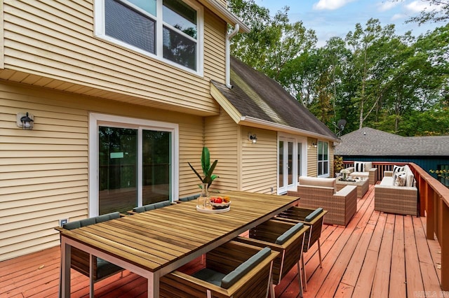 wooden terrace with outdoor lounge area, outdoor dining space, and french doors