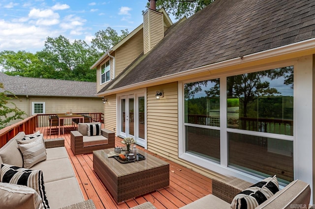wooden terrace featuring french doors and outdoor lounge area