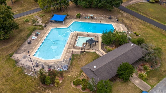 view of swimming pool featuring fence