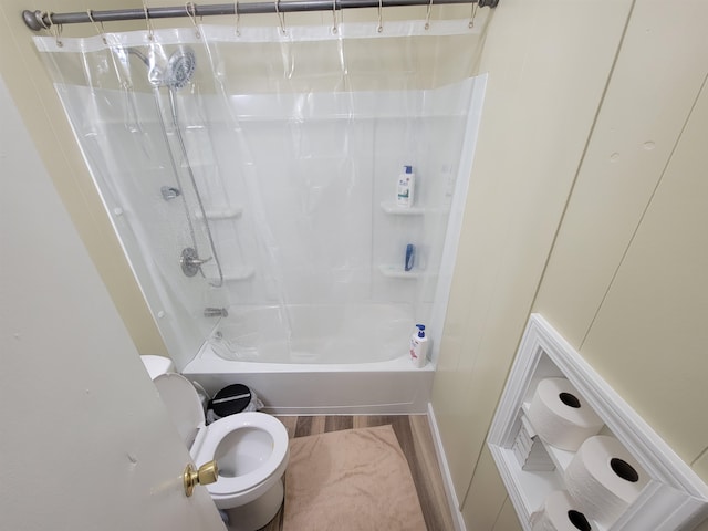 full bathroom featuring shower / bath combination with curtain, toilet, and wood finished floors