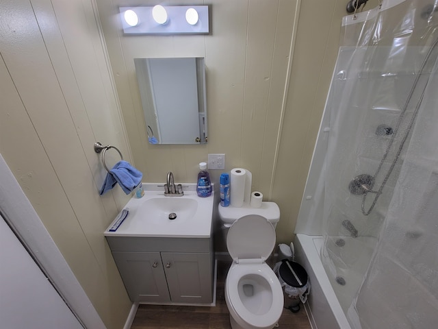 bathroom featuring vanity, toilet, wood finished floors, and shower / tub combo with curtain