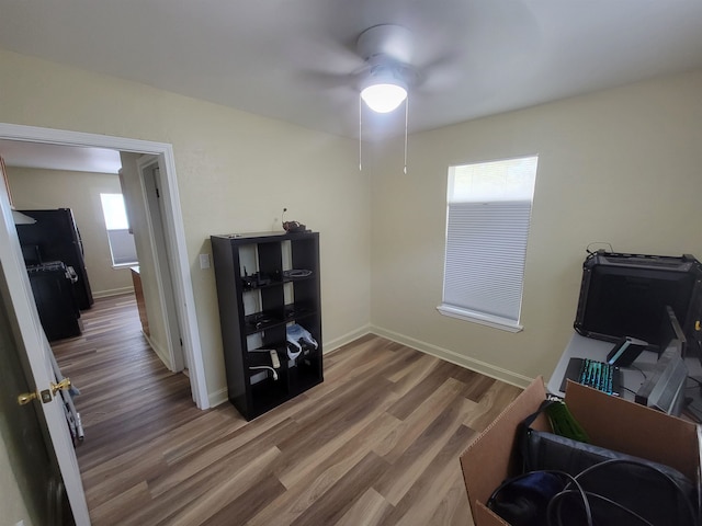 misc room with ceiling fan, baseboards, and wood finished floors