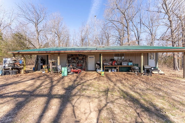 view of front facade with covered porch and metal roof