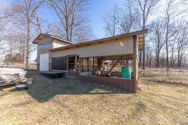 exterior space with a yard, an outbuilding, an outdoor structure, and fence