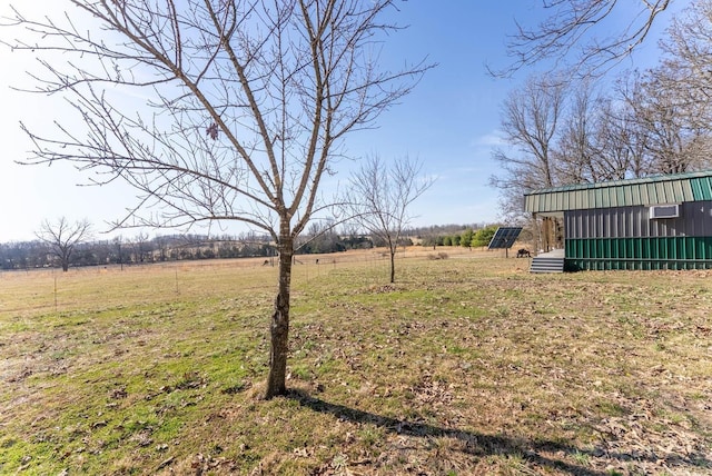 view of yard featuring a rural view and an outdoor structure