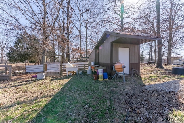 view of yard featuring an outdoor structure and a garden