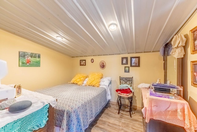 bedroom featuring lofted ceiling and wood finished floors