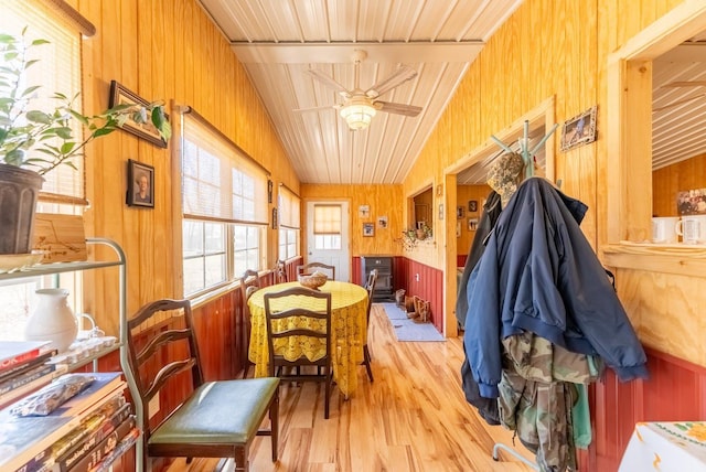 interior space featuring lofted ceiling, a wood stove, and ceiling fan