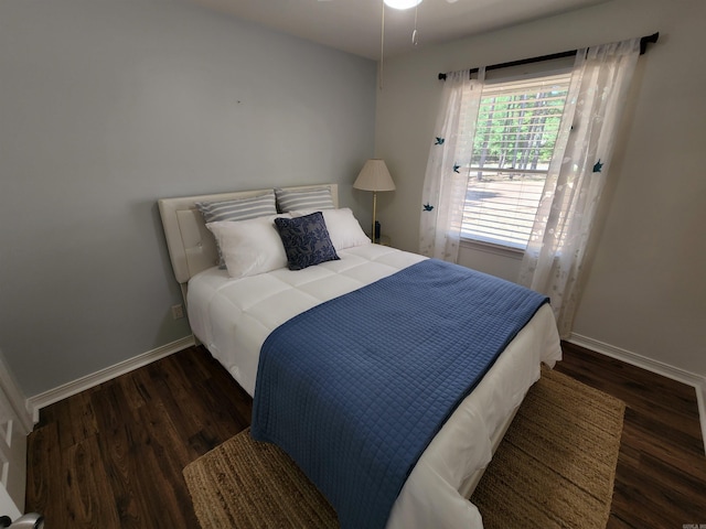 bedroom with baseboards and wood finished floors