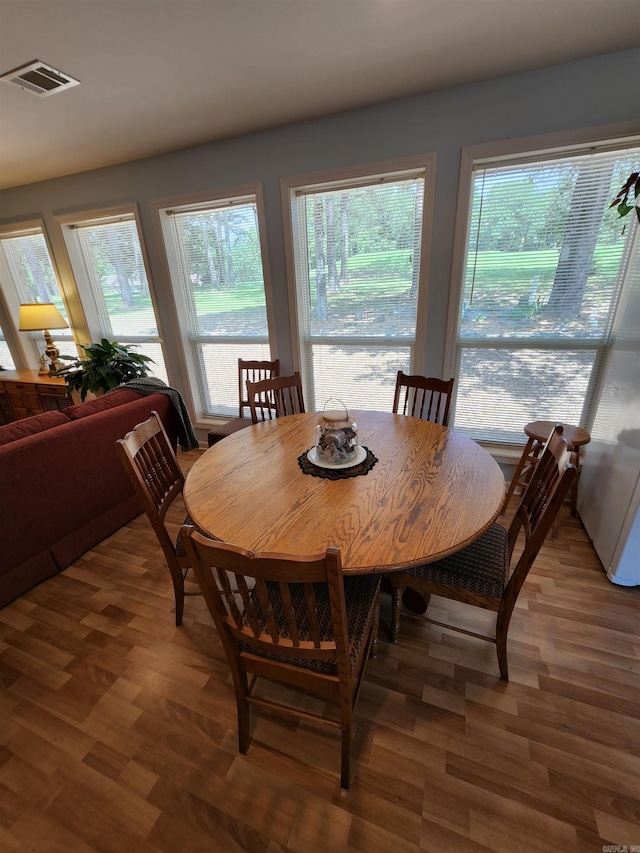 dining area featuring wood finished floors and visible vents