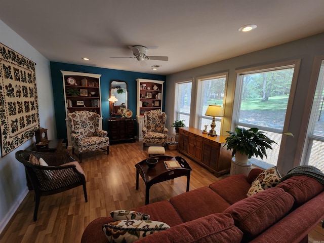 living room with recessed lighting, light wood-style floors, and ceiling fan