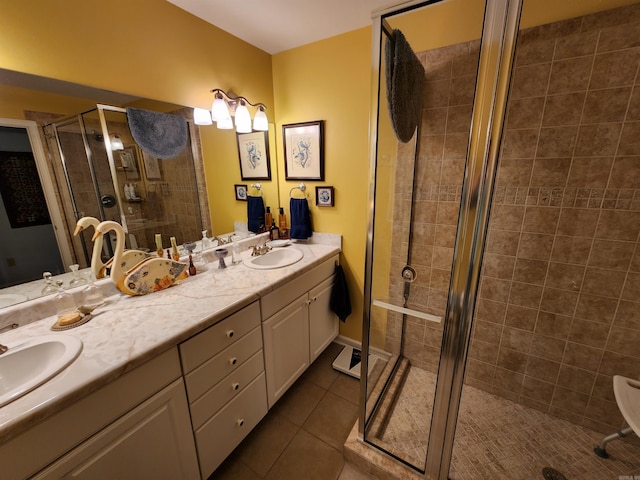 bathroom featuring tile patterned flooring, a shower stall, double vanity, and a sink