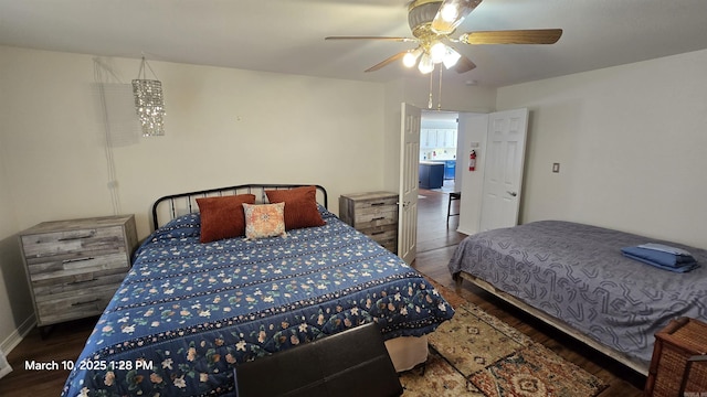 bedroom featuring a ceiling fan, wood finished floors, and baseboards