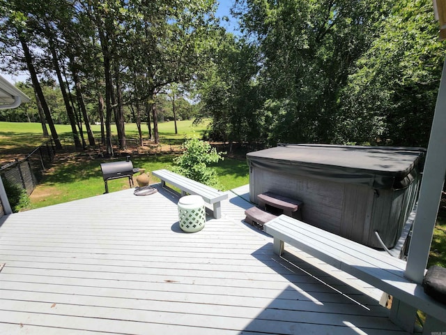 wooden deck with fence and a hot tub